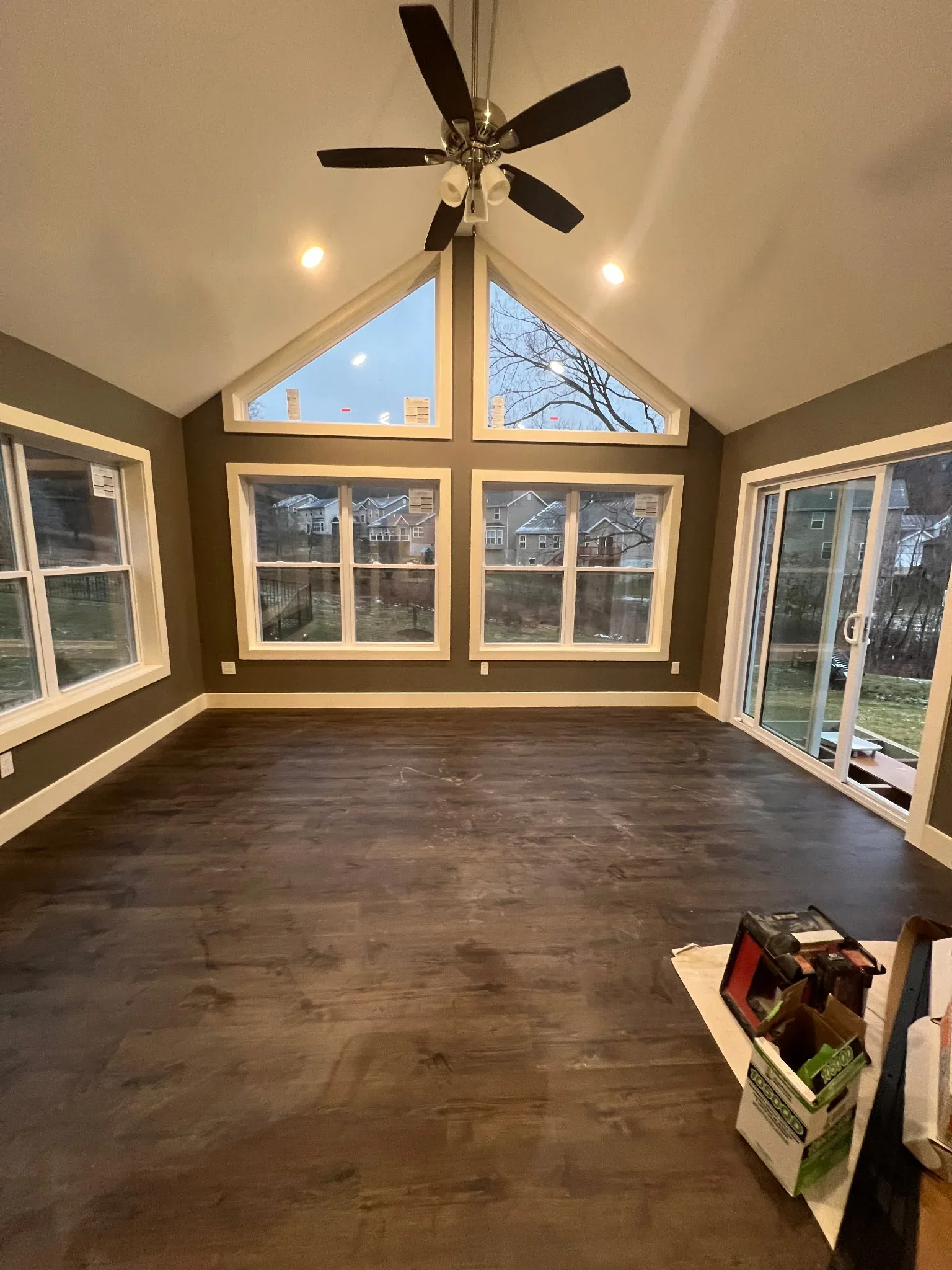 Vaulted sunroom with gable windows, recessed lights, ceiling fan, and glass doors